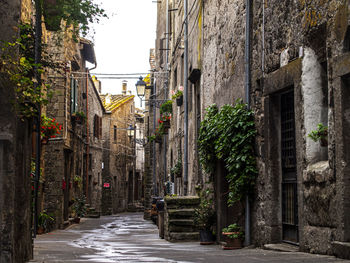 Footpath amidst buildings in city