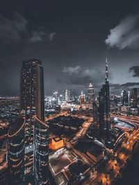 Illuminated cityscape against sky at night