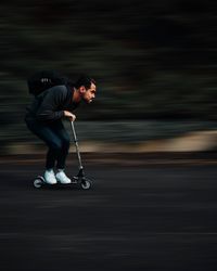 Full length of man on push scooter