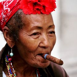 Close-up portrait of young woman smoking outdoors