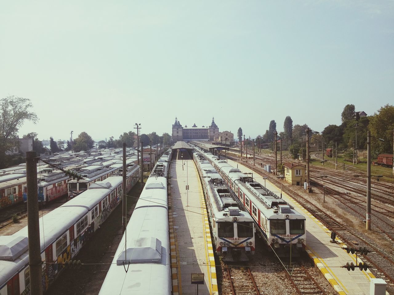 HIGH ANGLE VIEW OF TRAIN ON RAILROAD TRACK AGAINST CLEAR SKY