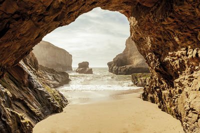 Scenic view of sea seen through cave