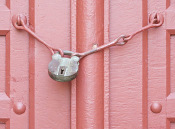 Close-up of padlock on wooden door