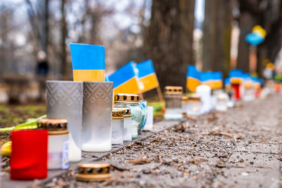 Thousands candles and flowers standing on the street during the war in ukraine