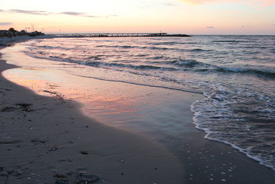 Scenic view of beach against sky during sunset