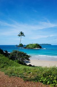 Scenic view of sea against blue sky