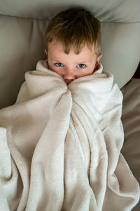 Cold season, a frozen boy covered with warm plaid