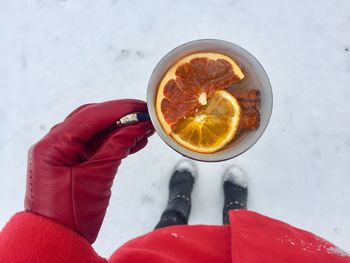 High angle view of woman holding drink during winter
