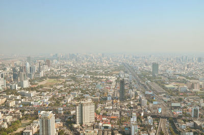 High angle view of modern buildings in city against clear sky