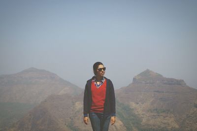 Portrait of woman standing on mountain