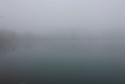 Scenic view of lake in foggy weather