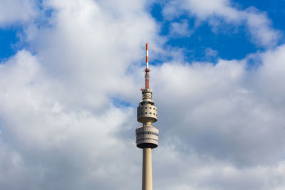 Low angle view of communications tower against sky