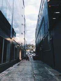 Street amidst buildings in city against sky