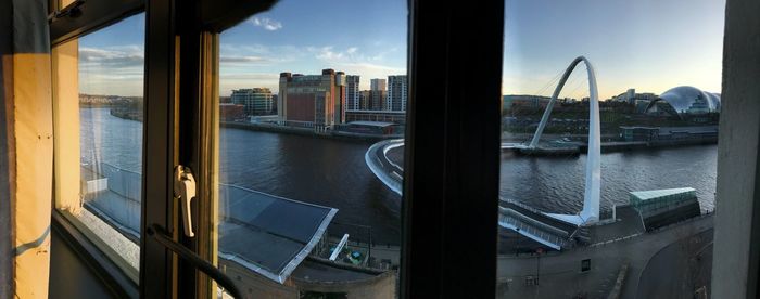 Cityscape by river seen through window