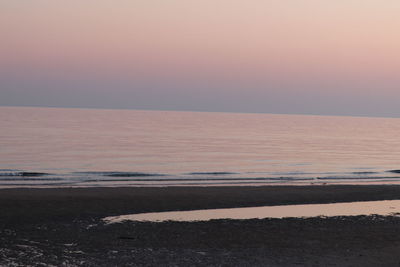 Scenic view of sea against clear sky during sunset