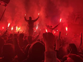 People enjoying music concert at night