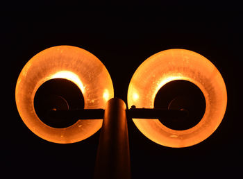 Low angle view of illuminated street light against sky during sunset