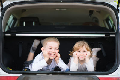 Portrait of happy boy in car