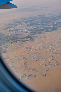 Aerial view of landscape seen through airplane window