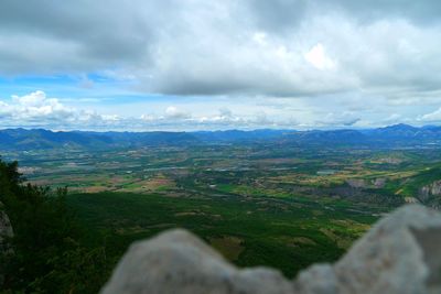 Scenic view of mountains against cloudy sky