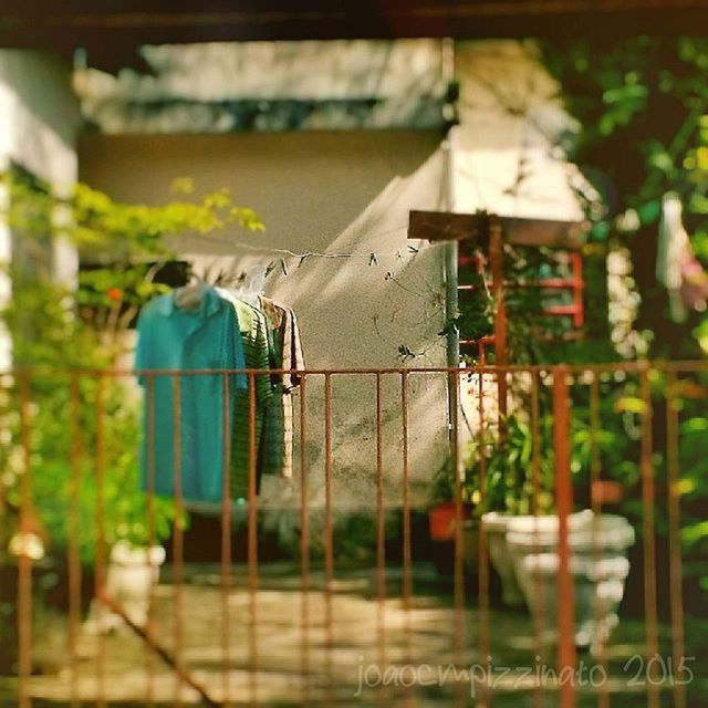 building exterior, architecture, built structure, focus on foreground, selective focus, hanging, fence, house, protection, focus on background, day, residential structure, safety, outdoors, clothesline, window, residential building, building, metal, railing