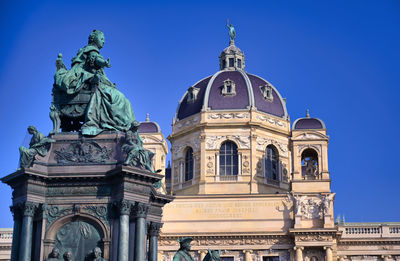 Low angle view of statue against blue sky