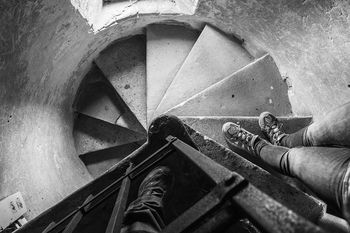 Low section of men standing at staircase