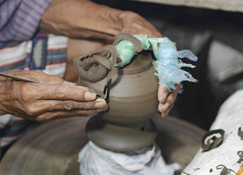 Midsection of man working at workshop