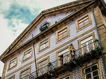 Low angle view of building against cloudy sky