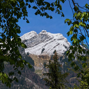 Low angle view of snowcapped mountain against sky