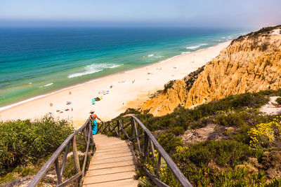 High angle view of woman walking on steps over sea