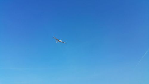 Low angle view of airplane flying in sky