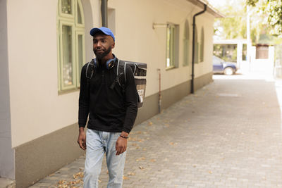 Portrait of young man standing on street