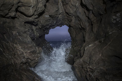 Pacific waves crash through a sea cave at leo carillo state park