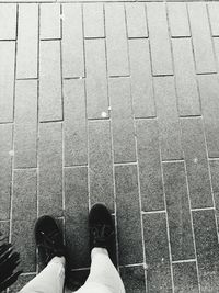 Low section of man standing on tiled floor