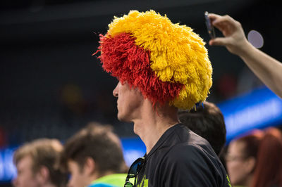 Close-up of man with multi colored crowd