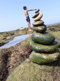 Full length of man standing on rocks