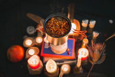 Close up camping pot with stew and candles concept photo