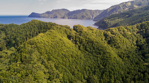 High angle view of sea and mountains against sky