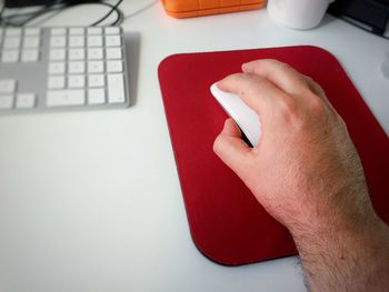 Cropped hand using mouse on table