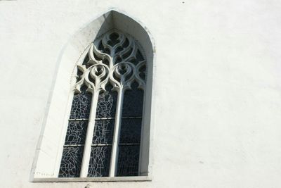 Low angle view of window on building wall