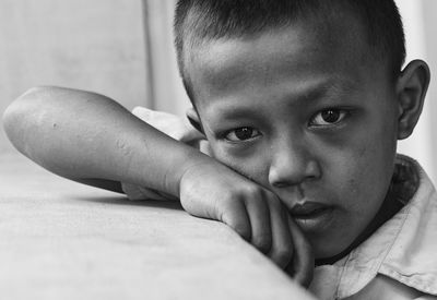 Close-up portrait of cute boy at home