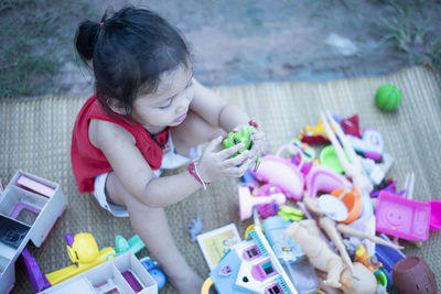 High angle view of boy playing with toys at home