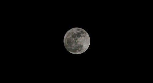 Low angle view of moon against clear sky at night