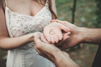 Midsection of couple holding hands