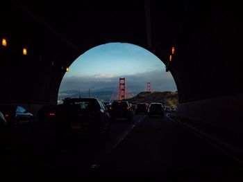 Cars on road in city against sky