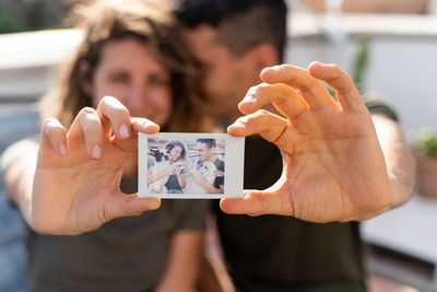 Portrait of woman photographing with mobile phone