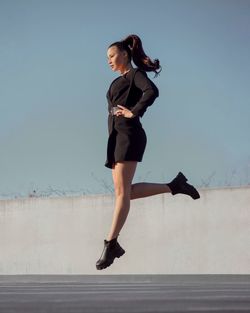 Full length of woman jumping outdoors