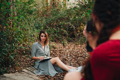 Young couple sitting in forest