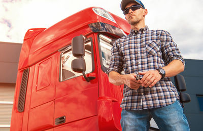 Rear view of man standing in car